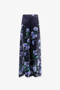 Lavi Women’s Frangipane ramie trousers in blue with black wide-leg pants featuring purple floral pattern and green leaves