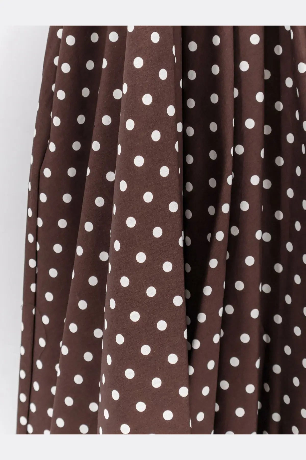 Brown cotton polka dot skirt with white circular patterns from lavi women’s mambo dress collection