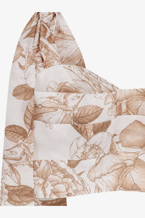 A delicate sheer scarf with an elegant floral pattern in soft beige and cream tones paired with lavi womens seraphina cotton top beige
