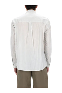 Our Legacy men’s above shirt white is a crisp white button-down with subtle vertical pinstripes and a tailored fit