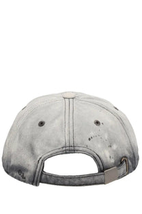 Our Legacy men’s cappello da baseball in denim grey with faded gray denim, distressed paint spots, and metallic silver buckle