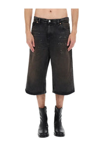 Our legacy men’s green capri cut shorts made of faded black distressed denim with a wide-leg design