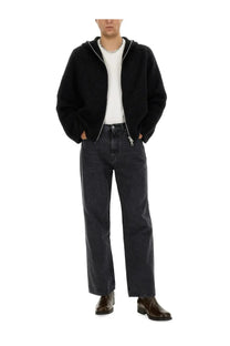 Our legacy men’s cardigan con zip black is a black faux-fur-lined zip-up hoodie with white inner lining and silver zipper