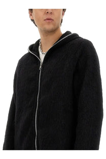 Our Legacy men’s black fuzzy zip-up hoodie with silver zipper and hood trim featuring soft textured fabric