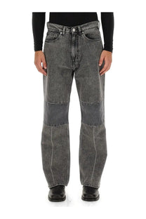 Dark gray wide-leg denim jeans with faded wash and reinforced knee patchwork from Our Legacy men’s collection