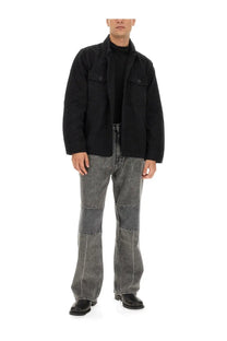Our Legacy men’s jeans extended third cut black black denim with faded patchwork design and flared legs