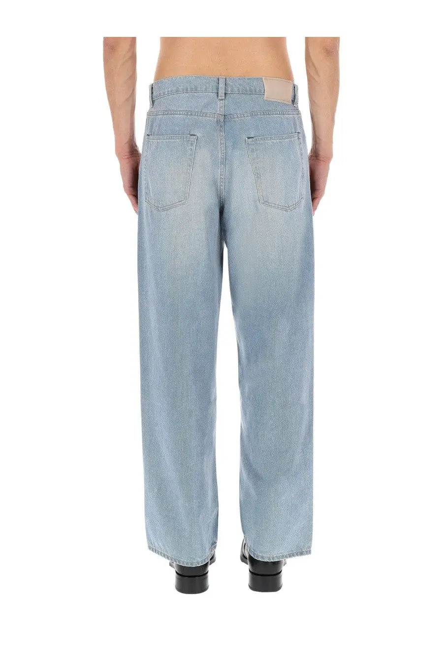 Our Legacy men’s light-wash denim jeans with a relaxed wide-leg cut shown from the back with classic pockets