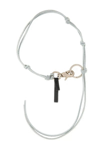 Our Legacy men’s leather keychain in blue with light gray cord, silver clasp, and black leather tag