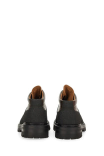 Our Legacy men’s leather quest shoe brown featuring black suede combat boots with brown leather lining and chunky rubber soles