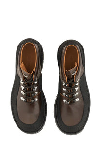 Our Legacy men’s leather quest shoe in brown features lace-up design with black rubber soles and silver eyelets