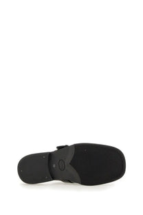 Black rubber sole with textured grip and molded heel counter of our legacy men’s mule camion black shown from back side