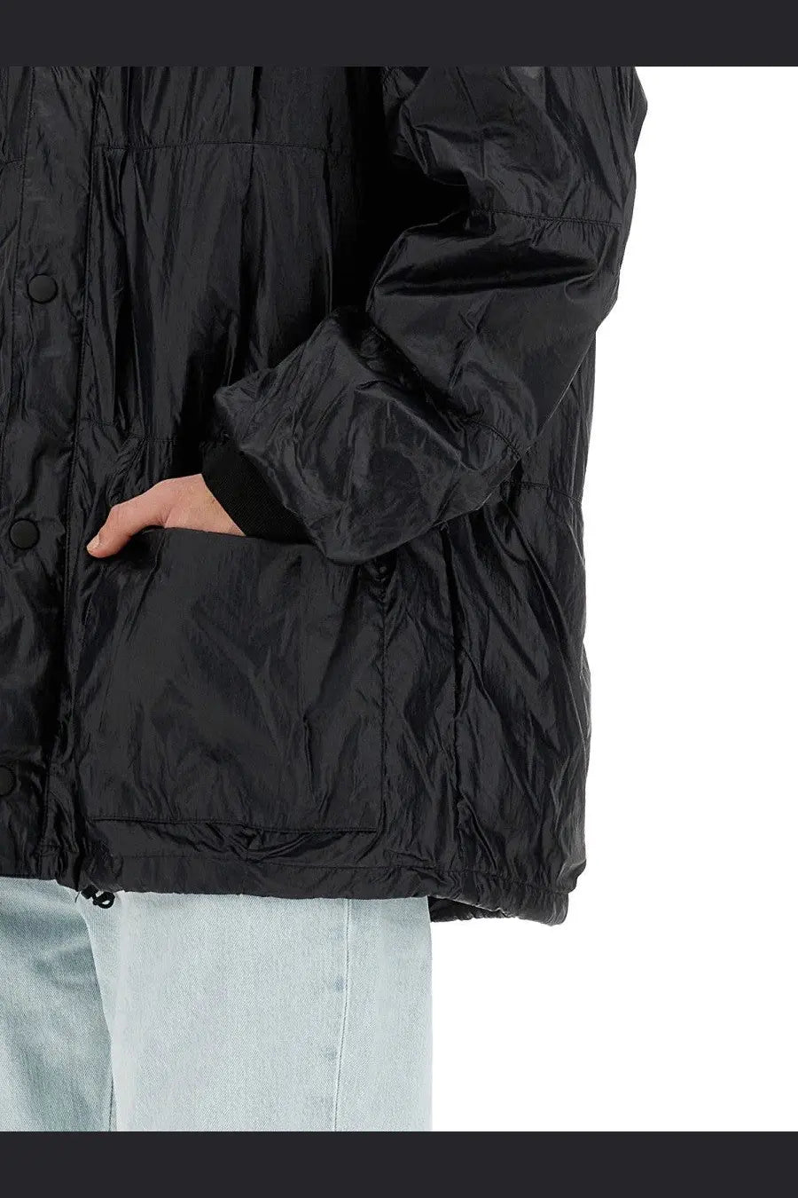 Our Legacy men’s black nylon puffer jacket with shiny quilted texture and button closures