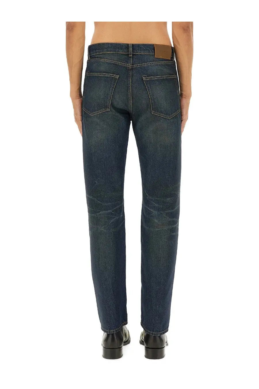 Our Legacy men’s dark indigo denim jeans with straight-leg cut and brown leather belt loops at the waistband