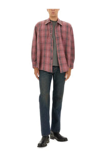 A relaxed-fit long-sleeved button-up shirt in faded red and dark gray plaid paired with our legacy men’s pants first cut blue