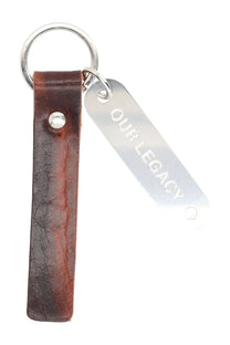 Brown leather keychain with silver metal tag engraved with our legacy from our legacy men’s portachiavi ring brown collection