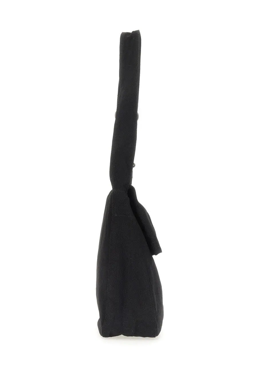 Our Legacy men’s sling bag black made of black canvas featuring a long slender handle and small tassel detail