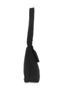 Our Legacy men’s sling bag black made of black canvas featuring a long slender handle and small tassel detail