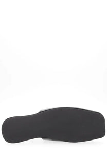 Our Legacy men’s slipper cigar black showing black rubber sole of minimalist slip-on shoe from the back side