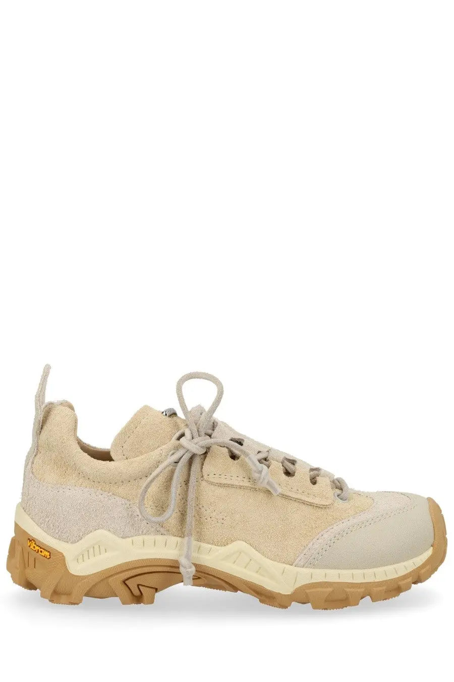 Our Legacy men’s sneaker Gabe beige is a beige suede and canvas low-top with tan rubber sole and vibram branding