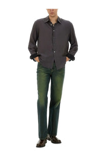 Dark gray button-up shirt with black cuffs and collar made of smooth shiny fabric paired with our legacy men’s straight leg green jeans