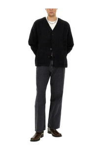 Black textured knit cardigan with button closure and front pockets paired with our legacy men’s third cut grey jeans