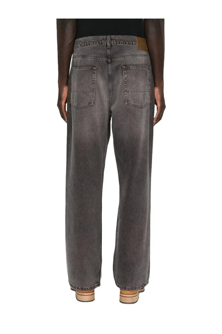 Our Legacy men’s third cut jeans grey shown from back are dark gray wide-leg denim with a faded wash and classic pockets