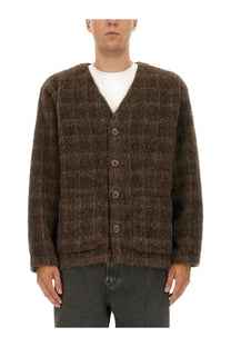 Our Legacy men’s brown wool blend cardigan with textured knit v-neck and button closure visible from the front