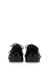 Black patent leather sneakers with chunky sole and laces from Our Legacy unisex Klove sneaker collection