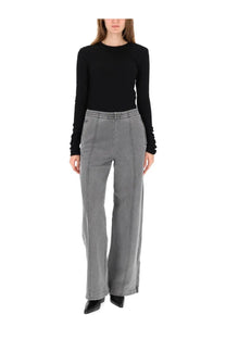 Gray wide-leg trousers with vertical seam detailing paired with Our Legacy women’s black long sleeve shirt