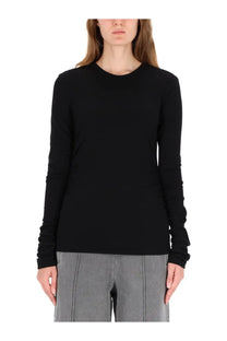 Our Legacy women’s long sleeve shirt in black features a simple crew neckline and subtle sleeve ruching