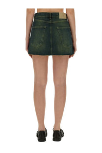 Back view of our legacy women’s malibu cover skirt green dark green denim mini skirt with two back pockets and tan label
