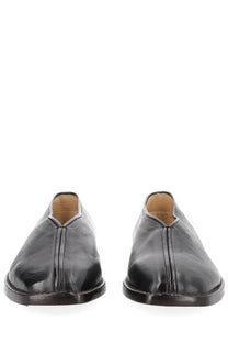 Lemaire men’s black leather moccasin-style flat piped slippers with glossy finish and subtle front stitching