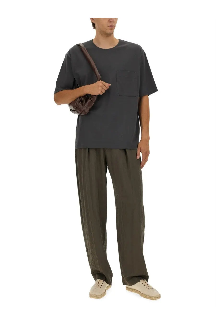 Dark brown leather shoulder bag with textured woven design paired with lemaire men’s relaxed fit grey shirt
