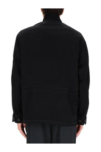Lemaire men’s soft field jacket in black cotton with subtle stitching details and buttoned cuffs visible in front view