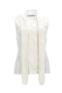 A white lemaire sleeveless blouse with asymmetrical ribbed fabric and button front design for women