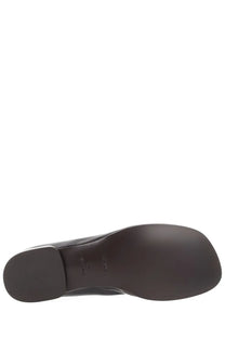 Back side of lemaire women’s ballerina glove in brown leather with smooth sole and subtle embossed branding near heel