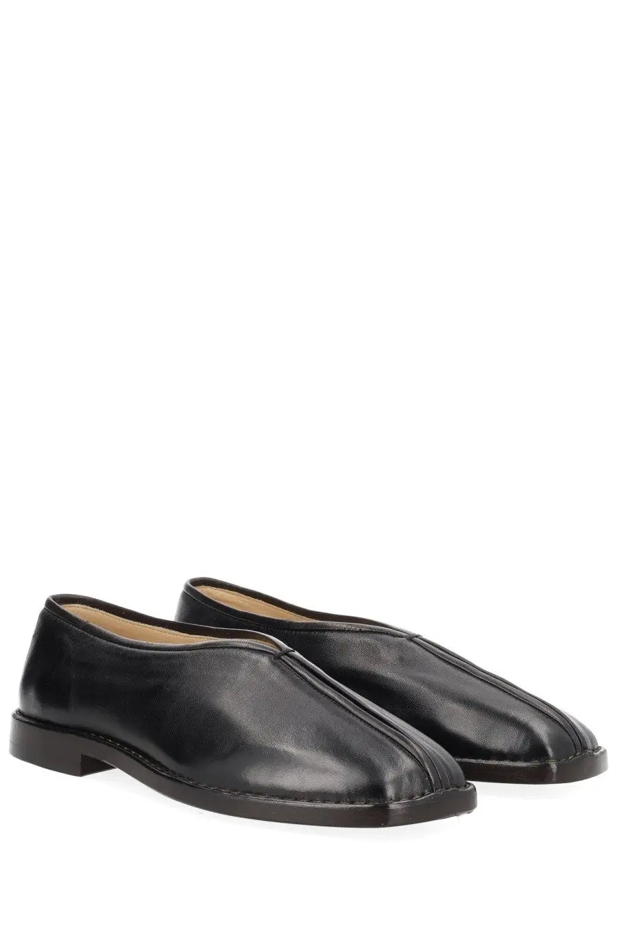 Lemaire women’s black leather flat piped slippers with sleek minimalist design and subtle stitching details
