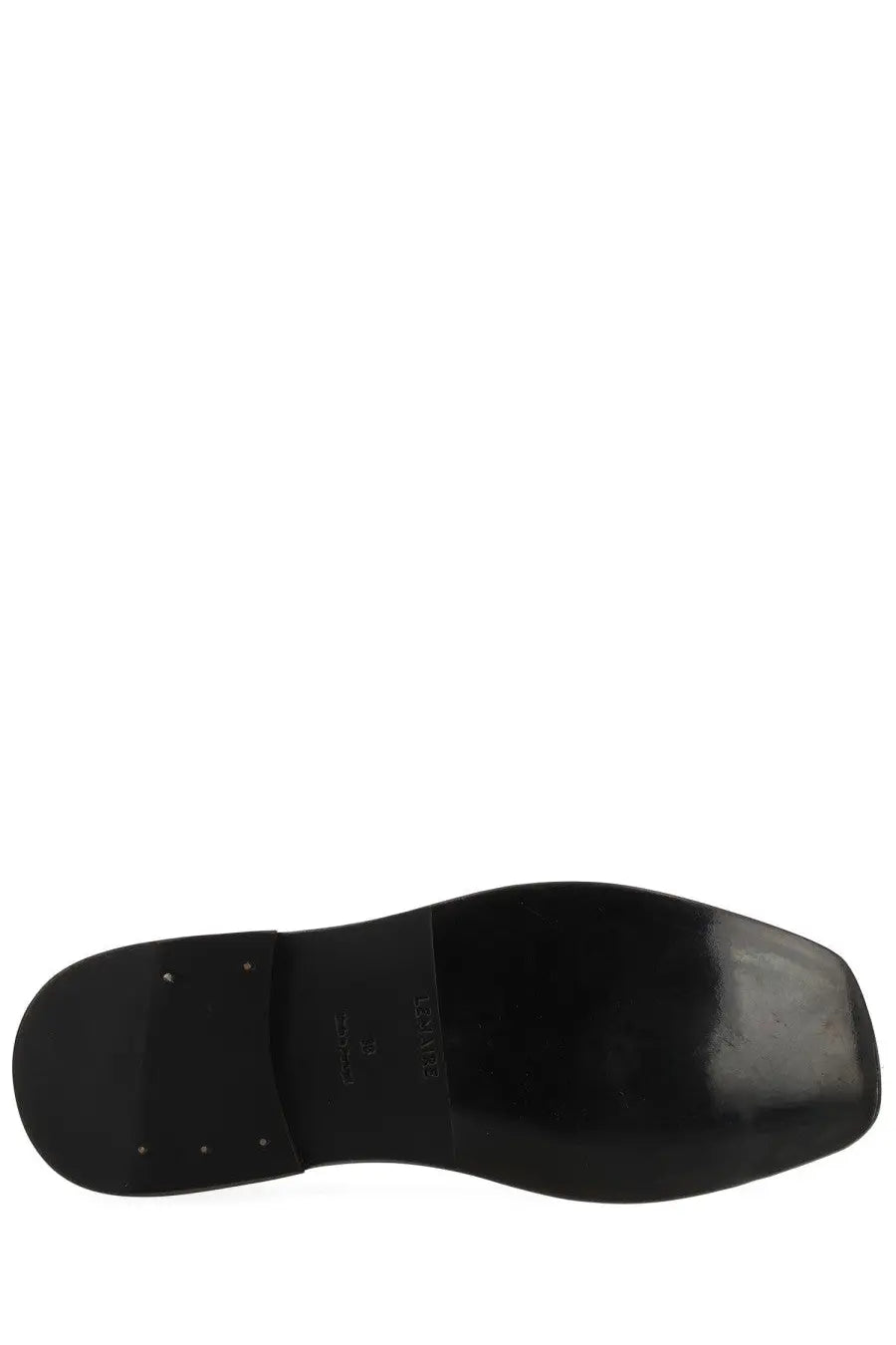 Sole of lemaire women’s black leather flat piped slipper with glossy finish and embossed branding visible on back side