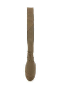 Tan over-the-knee boot with platform sole and smooth seamless material shown with lemaire women’s small croissant bag brown