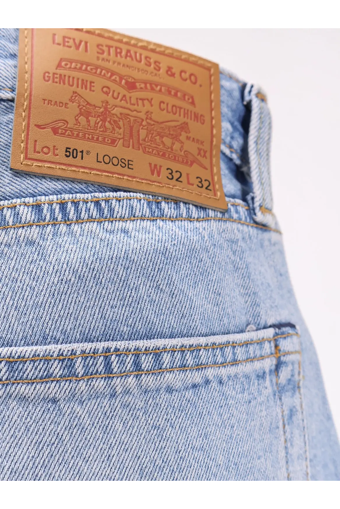 Levi’s men’s light-wash blue denim jeans with classic brown leather patch and red stitching on the back side