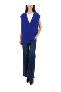 Lois jeans women’s black pants paired with a vibrant royal blue ribbed knit sleeveless vest with v-neck and asymmetrical hem