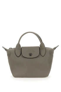 Gray Longchamp le pliage mini handbag with structured design and signature flap closure in beige color