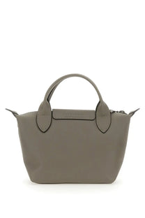 A sleek matte gray Longchamp Le Pliage mini handbag with structured handles and minimalist design for women