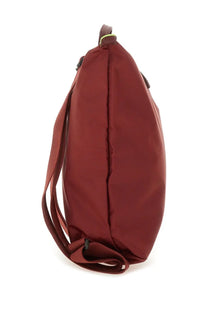 Longchamp women’s le pliage backpack red made of sleek maroon nylon with minimalist design and lime green zipper accents