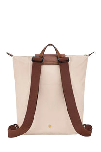 Beige Longchamp LE Pliage backpack with brown leather straps and gold-tone hardware in Longchamp Women’s pink collection