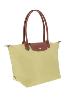 Longchamp women’s le pliage large tote bag in pale green with brown leather handles and matching flap closure