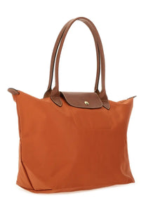 Longchamp women’s LE Pliage large tote bag in cognac color with brown leather handles and matching flap closure