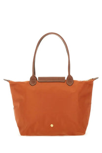Orange Longchamp LE Pliage large tote bag with brown leather handles and trim for women’s everyday use