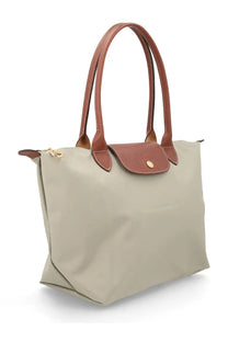 Beige longchamp le pliage medium tote bag with brown leather handles and flap in grey color for women