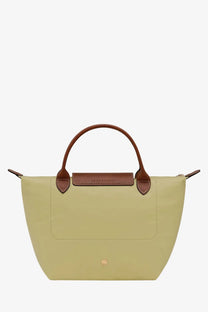 A pale green Longchamp women’s Le Pliage nylon tote bag with brown leather handles and flap